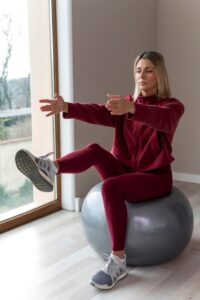 woman-using-fitness-ball-her-exercises_23-2148827611